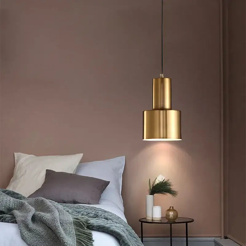A decorbites gold modern pendant light with a gold-toned cylindrical tiered design ideal for dining rooms