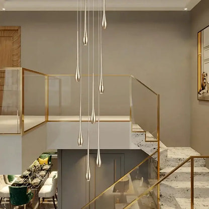 Modern silver teardrop pendant lights complement the decorbites gold-plated duplex teardrop chandelier living room light