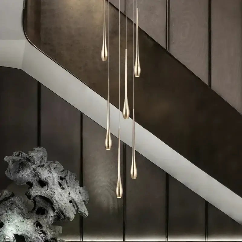 Five slender teardrop pendant lights with brushed gold finish from decorbites gold-plated duplex chandelier