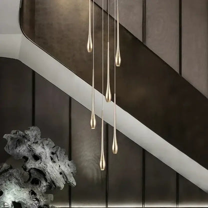Five slender teardrop pendant lights with brushed gold finish from decorbites gold-plated duplex chandelier