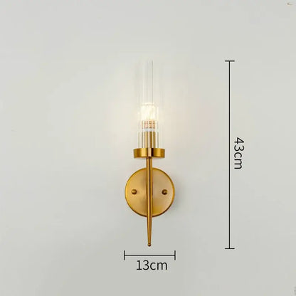 Gold plated nordic living room wall sconce with clear glass cylinder and circular brass plate by decorbites gold plated