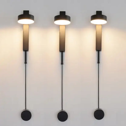 Three sleek black DecorBites™ wall lamps with cylindrical shades and dimmer switch for adjustable lighting