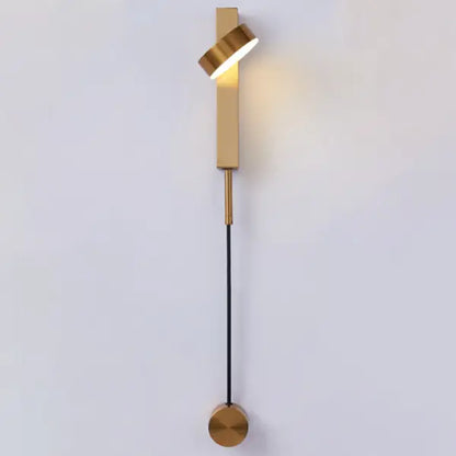 DecorBites gold wall lamp with dimmer switch featuring a sleek twisted cylindrical head and circular base in gold tone