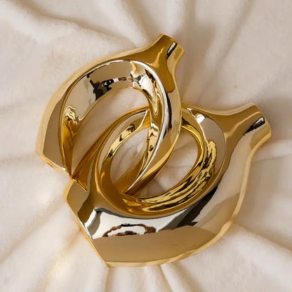 Shiny gold ceramic golden flower vase with interlocking ring-like forms from decorbites home decor accessory