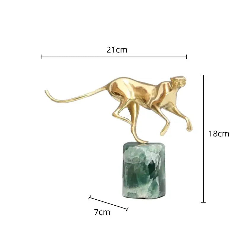 A decorbites golden leopard brass cheetah figurine in golden metallic finish standing on a green and white crystallized base