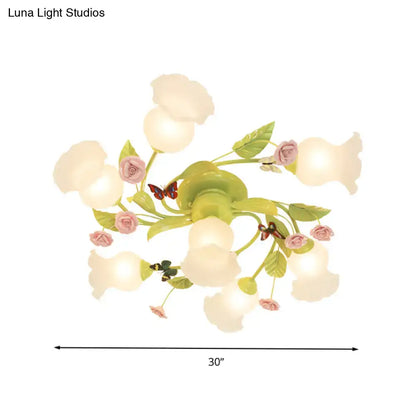 Decorbites green opaque glass spiral ceiling light fixture with pastel pink and green floral design and butterfly accents