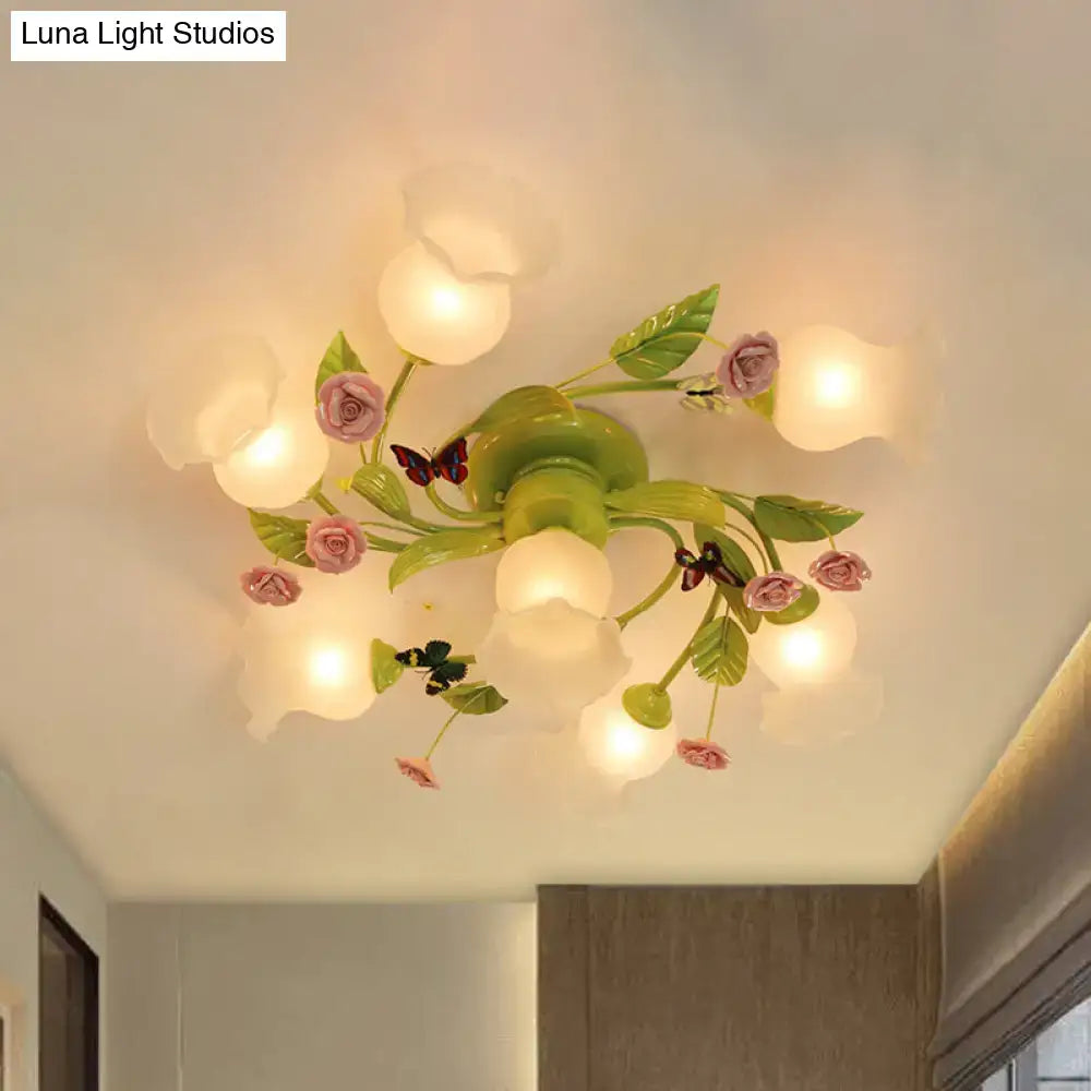 Decorbites green opaque glass spiral ceiling light fixture with pastel pink and green floral design and butterfly accents
