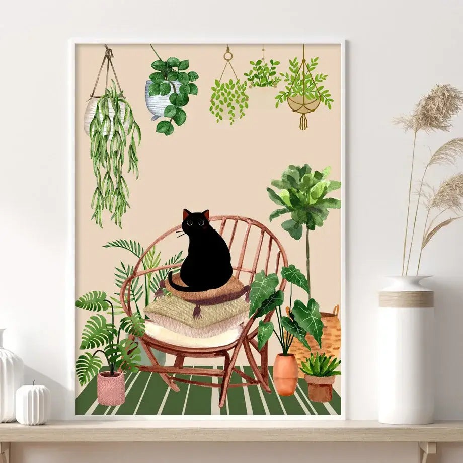 A framed decorbites™ canvas wall art featuring a black cat in a wicker chair surrounded by green plants against beige background