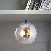 DecorBites™ grey glass pendant light with black fixture featuring a warm-toned filament bulb base for indoor use