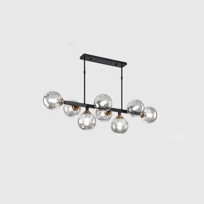 Modern black metal chandelier with seven hand-blown dimpled glass globe bulbs and gold-toned accents for restaurants