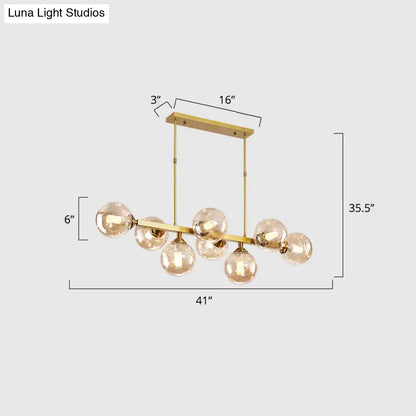 Gold-toned decorbites hand-blown dimpled glass chandelier with multiple spherical bulbs for modern restaurant use