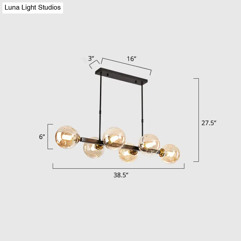 Black metal chandelier featuring five amber hand-blown dimpled glass globe bulbs for modern restaurant lighting