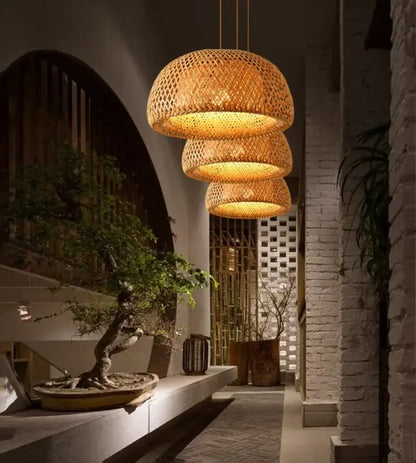 DecorBites™ handcrafted warm-toned three tiered woven bamboo pendant lamp in a modern interior setting
