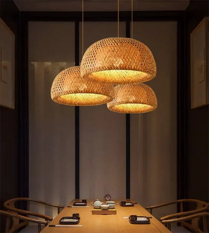 DecorBites handcrafted warm-toned bamboo pendant lamp with three woven lights in a modern dining space