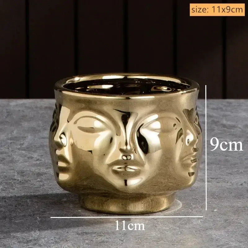 Golden handmade ceramic face art vase sculpture with three stylized faces for elegant home decor by DecorBites™