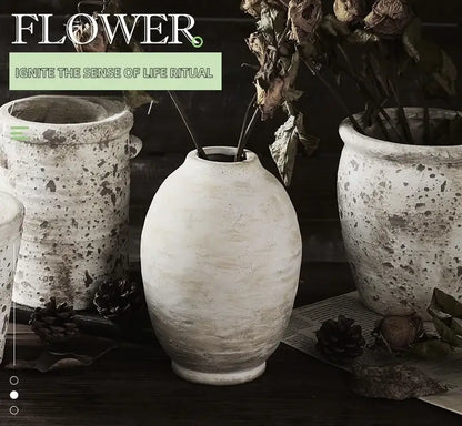 A rustic speckled white handmade ceramic vase with rounded body and narrow neck from decorbites vintage style home decor
