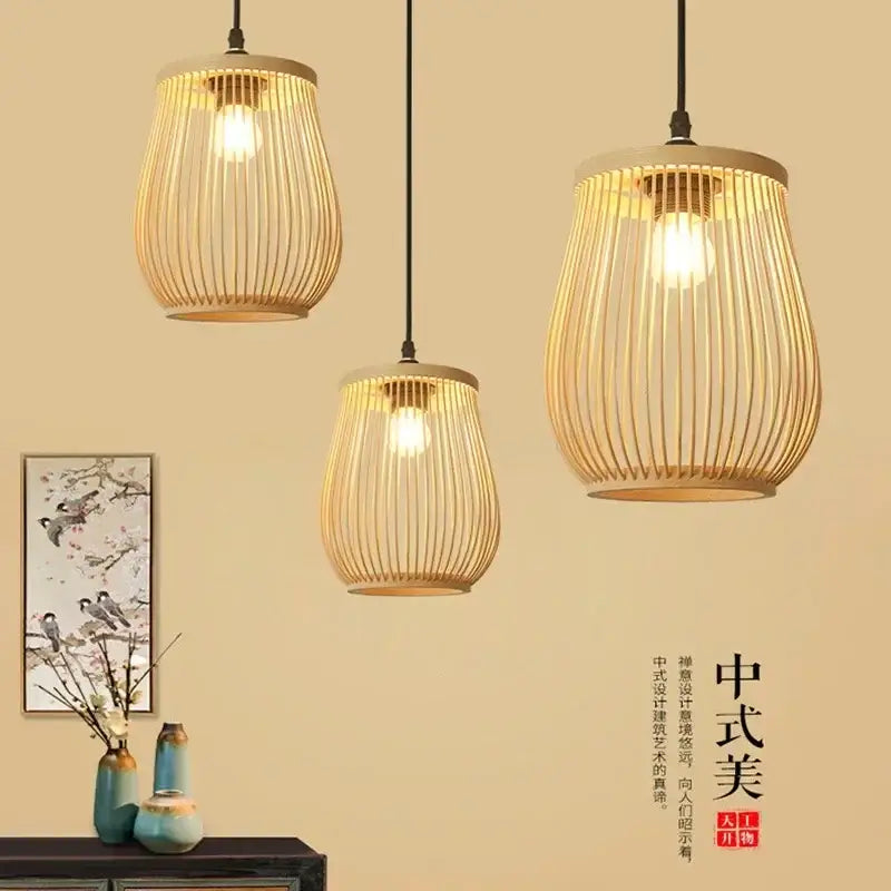 Three hanging pendant lights with cylindrical bamboo cages and warm lighting in DecorBites™ chinese rattan wicker pendant