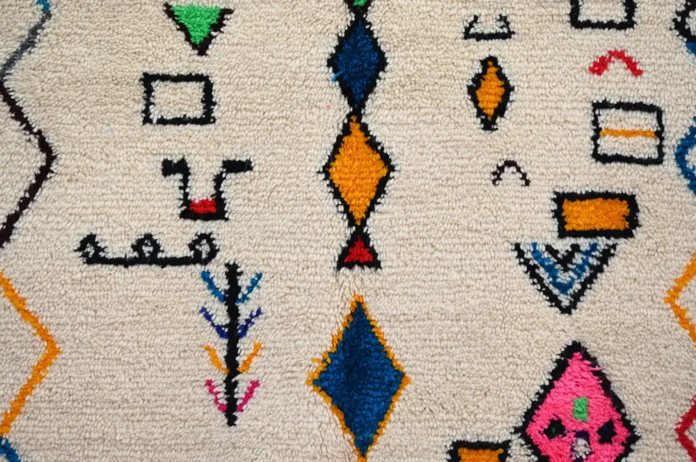 Beige handmade moroccan azilal rug with vibrant blue orange green and pink geometric patterns 222 x 139 cm