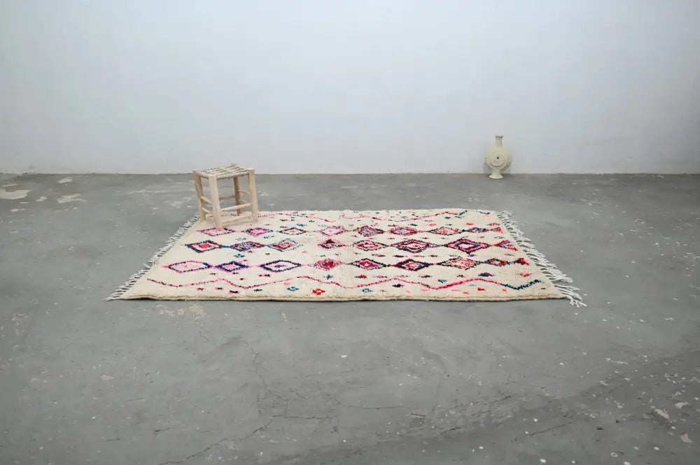 Beige DecorBites™ handmade traditional azilal rug with pink and red geometric patterns and fringed edges 230x154cm