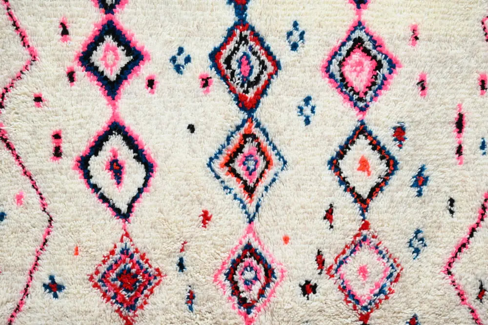 A plush off-white decorbites handmade traditional azilal rug 230x154cm with vibrant pink red and blue geometric diamond pattern
