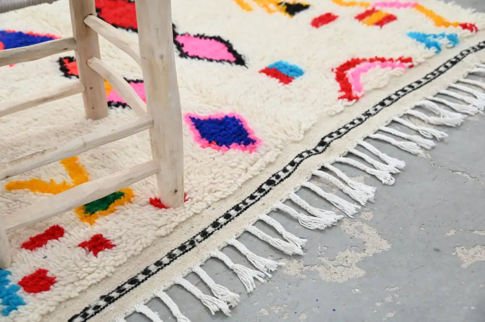 Decorbites™ handmade moroccan azilal rug 231x131cm features a vibrant cream base with bold geometric patterns in natural wool