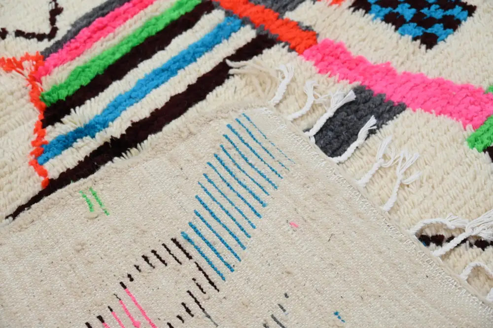 Decorbites™ handmade azilal rug in natural wool with vibrant colors and bold geometric patterns on a cream base