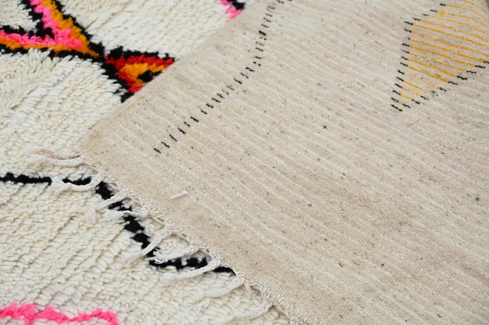 Beige woven azilal rug 240x150cm with bold pink orange black and yellow geometric patterns made of natural wool