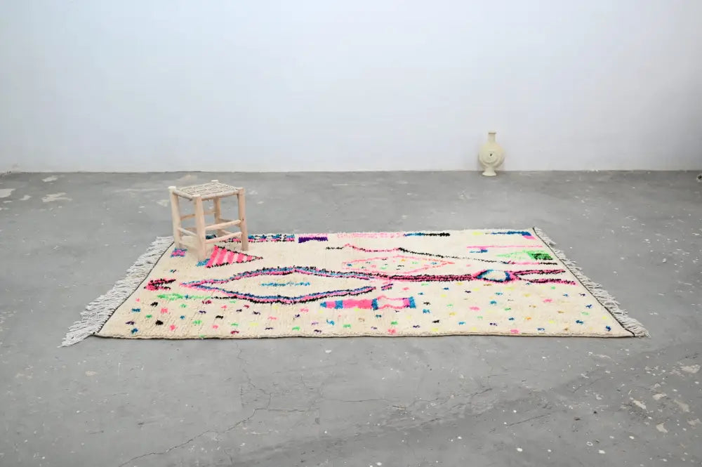 Decorbites™ handmade traditional azilal rug in cream with bold pink purple green and blue geometric patterns and fringed edges