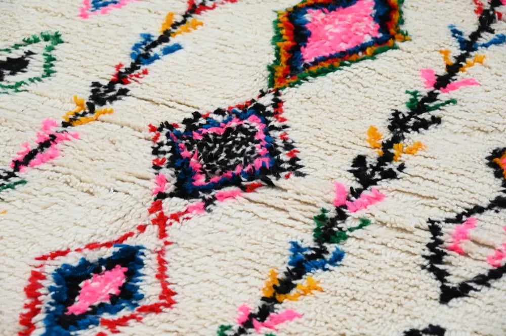 Vibrant decorbites™ handmade moroccan azilal rug with fluffy natural wool base and bold pink, blue, black, green, and red accents