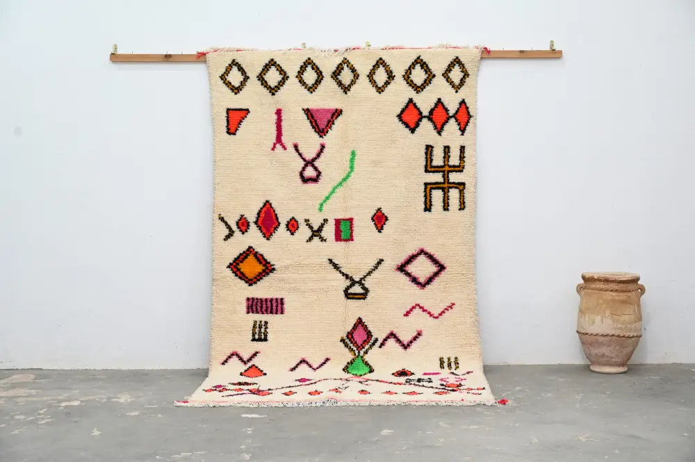 Beige handmade moroccan azilal rug with geometric patterns in red orange green and brown 247x146 cm by decorbites