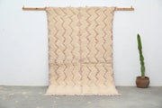 Beige and dusty rose handmade traditional azilal rug hanging on a wooden rod by decorbites 250x143cm