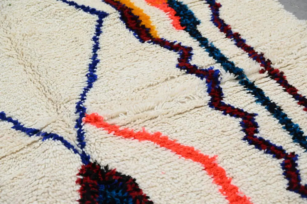 Cream-colored DecorBites™ handmade traditional azilal rug with bold blue red and orange stripes 250x145 cm