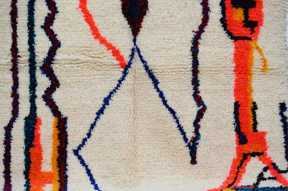 Cream-colored handmade traditional azilal rug with bold orange blue and dark red geometric patterns 250x145 cm