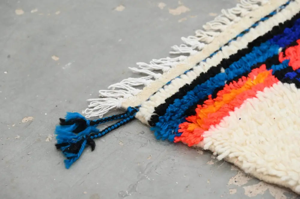 Decorbites handmade traditional azilal rug with bold blue black orange and cream stripes and fringed tassel edges 250x145 cm