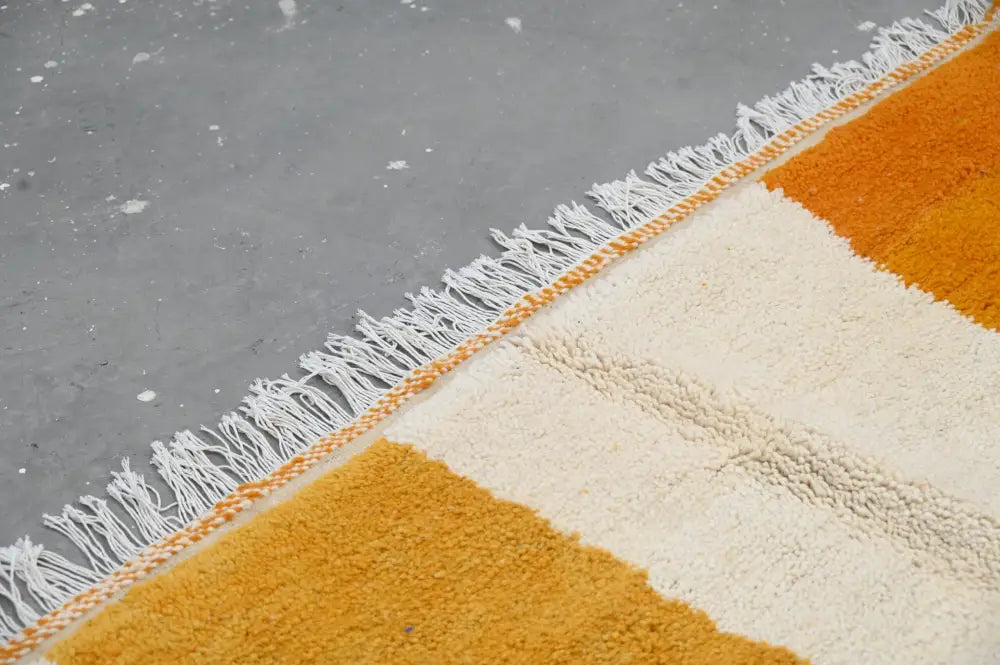Decorbites™ handmade traditional azilal rug with bold mustard and cream stripes and white fringe in wool