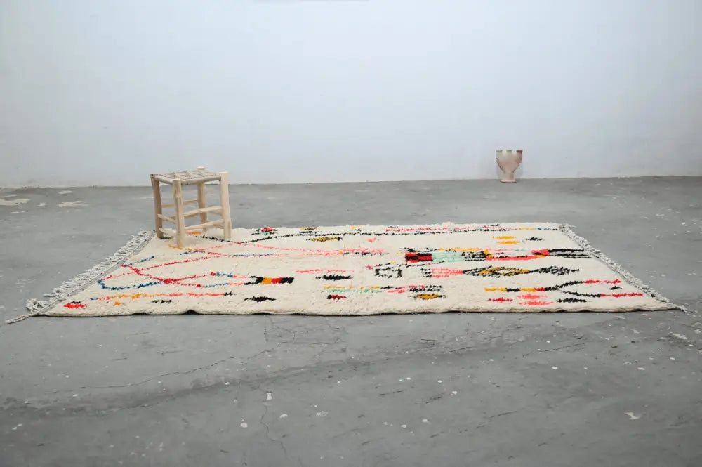 Beige wool DecorBites™ handmade moroccan azilal rug with colorful geometric patterns and fringed edges 250x154cm