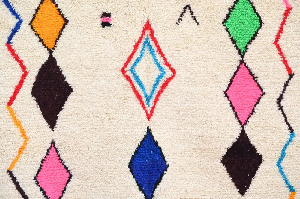 Vibrant geometric-patterned decorbites™ handmade azilal rug in bold colors on natural wool 250x160cm cream base