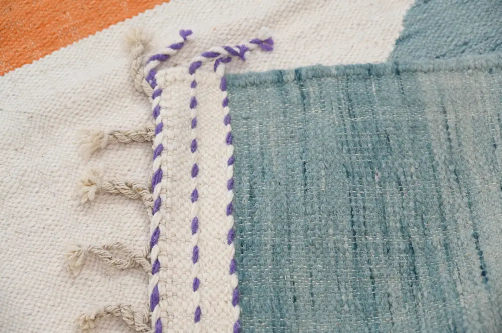 Decorbites™ handmade moroccan azilal rug in natural wool featuring white base with teal blue and purple braided border