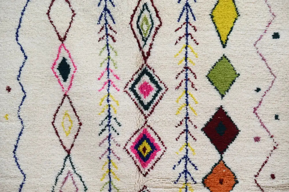 DecorBites™ handmade moroccan azilal rug with vibrant geometric patterns in pink green yellow and maroon on creamy white