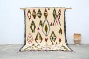 Beige handmade moroccan azilal rug with geometric olive green pink and black patterns and fringed edge 302x197 cm