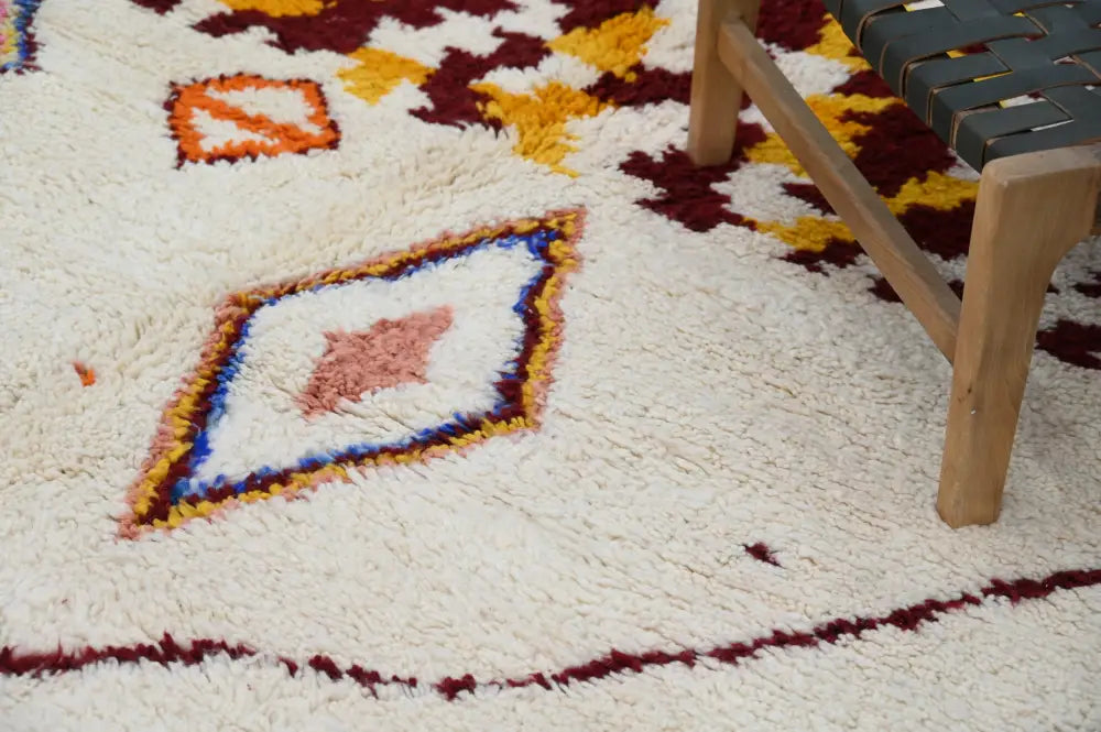 Cream-colored plush wool handmade moroccan azilal rug with maroon orange and blue geometric diamond pattern 309x207cm