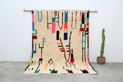 Beige moroccan azilal rug with vibrant pink blue green and black wool geometric patterns handmade 313x194cm decorbites
