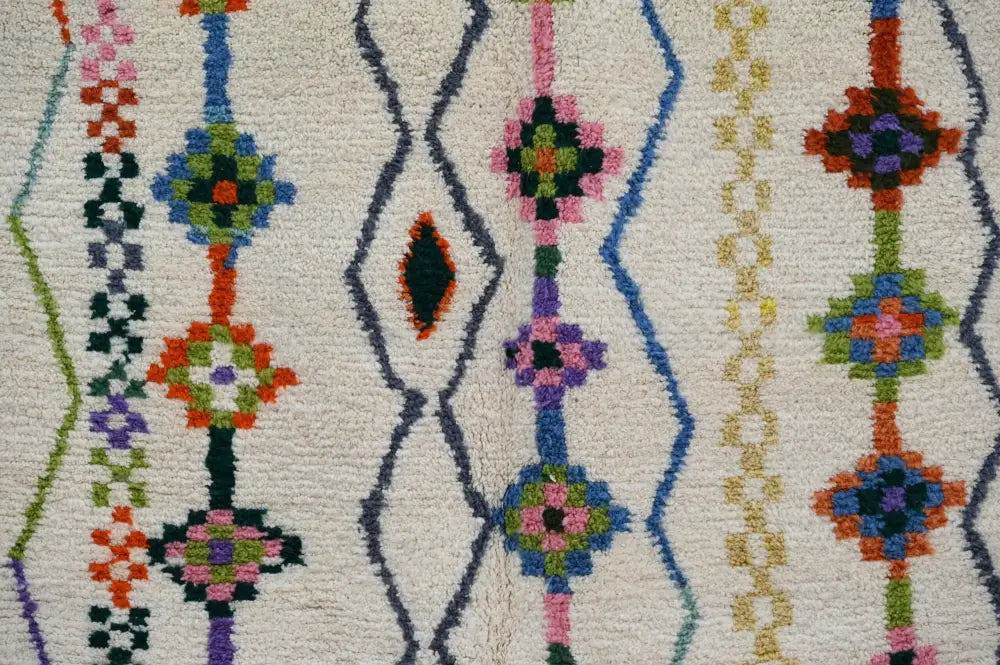 DecorBites™ handmade traditional azilal rug with cream base and vibrant geometric patterns in blue green pink and orange