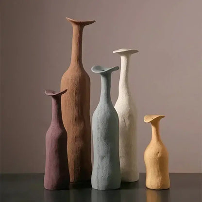 A set of five handcrafted ceramic flower vases in earthy tones with unique sculpted shapes for luxury home decor