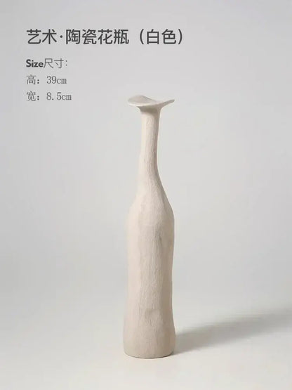 A tall white ceramic flower vase with a smooth textured surface and elongated neck by DecorBites™ for luxury home