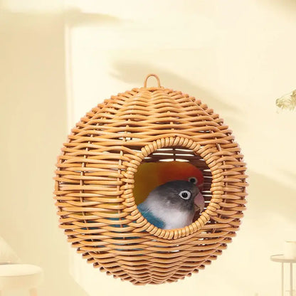 DecorBites™ handwoven grass bird cage with heart-shaped opening housing two colorful parrots in a wicker nest