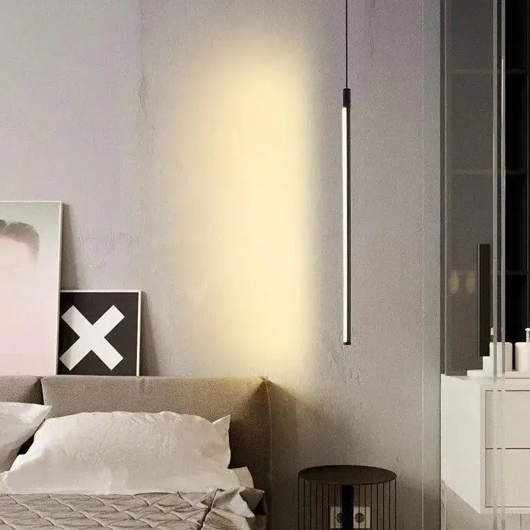 Decorbites™ hanging pendant lights featuring a minimalist black cylindrical design emitting warm glow for bedroom use