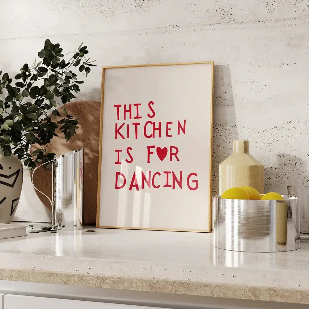 A framed wall art painting by decorbites with heart red quote text on a cream background in a light wood frame