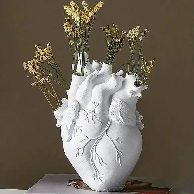 White ceramic DecorBites™ heart shape resin vase with detailed anatomy holding dried yellow and white flowers
