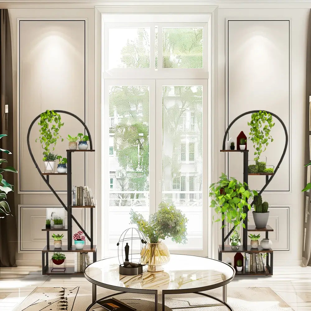 Black metal heart shaped plant stand by DecorBites with 6 tiers holding potted plants and decorative items